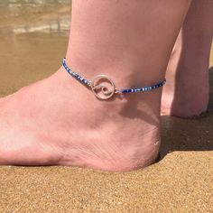 Life's a beach. Enjoy the waves.Anklet with mixed blue tiny glass seed beads and a silvertone wave charm. The diameter of the wave charm measures approximately 20mm (13/16").The anklet has a small extension chain, so you can adjust the length a bit.Every Flor anklet has a handstamped brand tag.****************************************I am happy to make the anklets to size. After placing your order you will therefore receive a message with instructions on how to measure the ankle circumference. If Cheap Blue Anklets With Colorful Beads, Silver Strand Anklets For Beach Season, Blue Beaded Ocean-inspired Anklet, Ocean-inspired Blue Beaded Anklet, Blue Tiny Beads Jewelry For Beach Season, Silver Anklets With Tiny Beads For Beach, Silver Beaded Bracelets With Tiny Beads For Beach, Silver Beach Jewelry With Tiny Beads, Small Extension