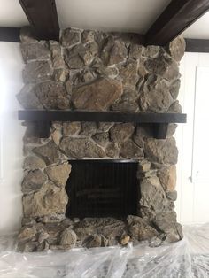 a large stone fireplace in the middle of a room