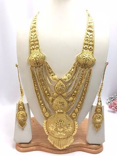 Handmade Indian Jewelry Asian Wedding Bridal Jewellery Party Ethnic Wear 22ct Gold Plated Bridal Necklace Set Rani Haar Bridal Jewellery Set  PLEASE NOTE, This Item Is Not Real Gold .Only Good Quality Gold Plated Jewellery .it is Artificial Jewellery.  It is a perfect match with formal attire on special occasions or with casual wearing.  Slight Colour variations possible due to difference in screen and photograph Care instructions Keep Jewellery away from direct heat, water, perfumes, deodorants Gold Temple Jewelry Tikka For Eid, Gold Kundan Necklace With Cutdana For Eid, Gold Plated Tikka For Festivals, Ceremonial Gold Tikka With Zari Work, Gold Tikka With Zari Work For Puja, Gold Tikka For Wedding And Diwali, Festive Gold-plated Tikka, Gold Wedding Tikka For Diwali, Gold Kundan Necklace Bollywood Style For Eid