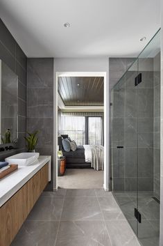 a large bathroom with a walk in shower next to a bathtub and sink area