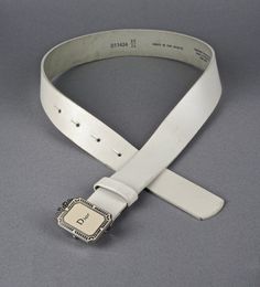 Features: - 100% Authentic CHRISTIAN DIOR. - Iconic Dior bow frame buckle with logo and enamel. - White calf leather strap. - Silver tone hardware. - Stamped with serial number, size 60/24 on reverse. - Some dirt on the leather as shown in the photos. - Good vintage condition. Measurements: Buckle Height: 1.77 inches (4.5 cm) Strap Height: 1.18 inches (3 cm) Wearable Length: 21.85 inches to 25.78 inches (55.5 cm until 65.5 cm) **This belt will be shipped via Priority Shipping with tracking numbe Designer White Leather Belts, Designer White Belts For Formal Occasion, Designer White Belt For Formal Occasions, Christian Dior Logo, Dior Logo, Vintage Christian Dior, Jeweled Earrings, White Belt, Christian Lacroix