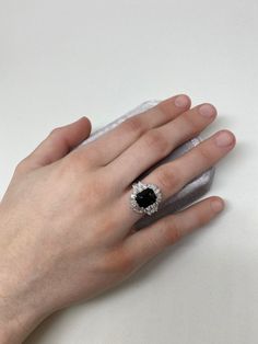 Start a conversation with this show stopping Art Deco inspired ring. A show stopping 4.22 ct black Spinel is the centerpiece of this creation, surrounded by a combination of 1.6 ct VS quality round, pear, and tapered baguette shaped diamonds. Inspired by the Art Deco period, we have created both contrast and symmetry with the depth of black hue from the Spinel and the contrast of the scintillating symmetrical diamonds that surround it. A collector piece sure to be an heirloom for many generation Luxury Evening Rings With Gemstone, Formal Cluster Ring With Accent Stones And Open Shape, Formal Cluster Ring With Accent Stones, Luxury Sapphire Rings For Evening, Exquisite Evening Gemstone Rings, Timeless Black Sapphire Ring As A Gift, Luxury Black Spinel Jewelry For Formal Occasions, Luxury Black Spinel Jewelry For Formal Events, Classic Black Baguette Cut Rings