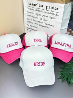 three pink and white hats sitting on top of a table