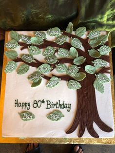 a birthday cake decorated with a tree and the words happy 80th birthday on it