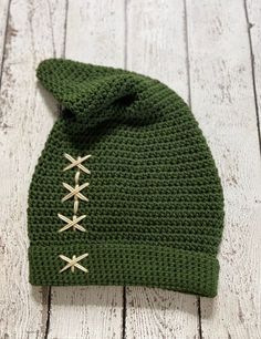 This adorable elf hat is inspired by the infamous Zelda game character Link. It is made in a forest green acrylic yarn with light beige stitches. It is available in size newborn all the way up to adult. It can also be custom designed in different colors upon request. Please make sure to message me prior to placing your order if you are wanting to change the color, to ensure that the color you are wanting is available.  *Made in a smoke/bug free home* **Item contains small parts that could pose a Zelda Game, Green Elf, Crochet Green, Beige Crochet, Elf Hat, All The Way Up, Skull Cap Beanie, Crochet Hat, Skull Cap