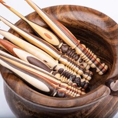 a bowl filled with lots of wooden spoons