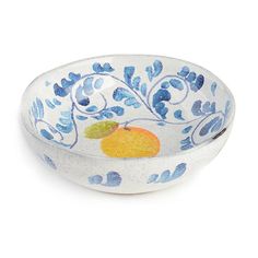 a blue and white bowl with fruit painted on the side, sitting in front of a white background