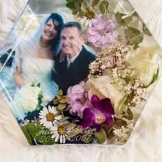 an image of a couple on their wedding day with flowers and greenery in the background