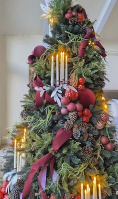 a decorated christmas tree with candles and ornaments