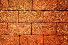 an orange brick wall with small cracks in it