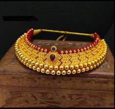 Vajratik jewellery is a traditional jewellery that is made by closely placing golden balls filled with wax to form sturdy jewellery. It has become famous all over India because of its lightweight and budget-friendly price point. This beautiful ornament is completely handmade which reflect Marathi karagiri. The necklace has adjustable thread attached. Diwali Temple Jewelry Style Round Choker, Traditional Round Choker For Festivals, Festive Round Temple Jewelry Choker, Gold Cutdana Bridal Necklace For Rituals, Gold Bridal Necklace With Cutdana For Rituals, Ceremonial Temple Jewelry Choker, Adjustable Gold Kundan Necklace In Temple Jewelry Style, Ceremonial Round Choker For Festivals, Traditional Adjustable Gold Kundan Necklace