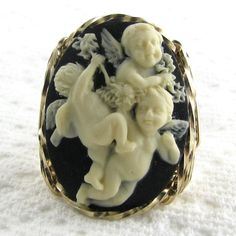 "Baby Angel Cherubs Cameo Ring Adorable and large 18x25mm fashion molded cameo hand sculpted in the finest Jeweler's 14K Rolled Gold Filled custom designed setting. Slightly raised intricate detailing for that 3-D elegant look against a black background Measures 1\" in length x 3/4\" in width Lightweight and comfortable when worn with casual or formal attire Size: 8 Will Custom Make Or Size To Fit At No Additional Cost Per Request Sizes Available: 5-15 Half Sizes Included Specify ring size in ch Silver Wire Jewelry, Unicorn Ring, Cameo Jewelry, Cameo Ring, Baby Angel, Fine Jewels, Formal Attire, Ring Sterling Silver, 925 Sterling Silver Jewelry