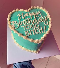 a heart shaped birthday cake sitting on top of a table