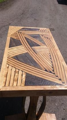 a wooden table sitting on the side of a road