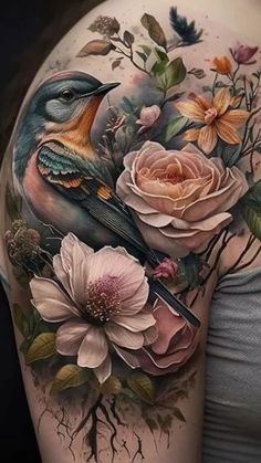 a woman's arm with flowers and a bird on it