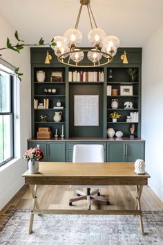 an office with built in bookcases and a desk