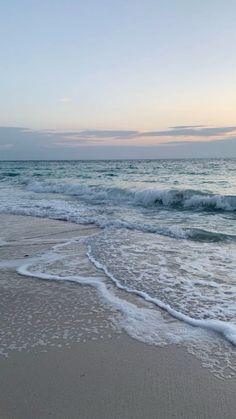 the ocean waves are coming in to the beach