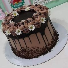 a cake with chocolate frosting and flowers on top