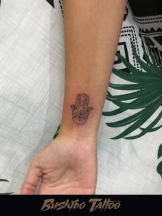 a person with a small tattoo on their wrist