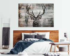 a deer head mounted to the side of a wall above a bed