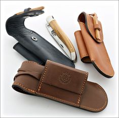 three different types of leather knives and sheaths