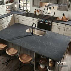 a kitchen with an island, sink and stove