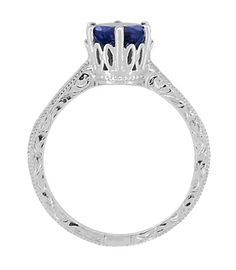 This beautiful Art Deco crown blue sapphire engagement ring in luxurious platinum features a secure six prong regal vintage filigree crown set with a stunning round brilliant cut natural deep royal blue sapphire gemstone ( September Birthstone ) of 1.54 carats. A romantic engraved scroll pattern on the three outward facing sides of the ring is bordered with light scattering millgrain beaded edging. Measurements for the ring are 7.9 millimeters wide at the top of the setting, with the band of the Art Deco Crown, Blue Sapphire Promise Ring, Unique Engagement Rings Sapphire, Crown Engagement Ring, Birthstone Engagement Rings, Amethyst Engagement Ring, Art Deco Filigree, Vintage Engagement Rings Sapphire, Garnet Engagement Ring