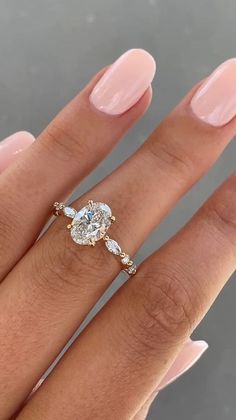 a woman's hand with a ring on her finger and a diamond in the middle