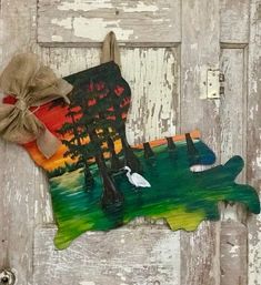 an image of a door with a bird painted on it and a bow hanging from the handle