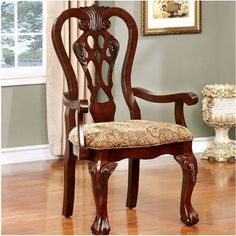 a wooden chair sitting on top of a hard wood floor in front of a window