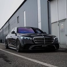 a black car parked in front of a building