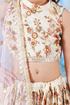 Cream lehenga featuring floral thread and sequin embroidery with handmade tassels. Paired with a matching embroidered blouse with lace detailing and a dupatta. - Aza Fashions Sleeveless Lehenga With Floral Embroidery For Eid, Sleeveless Floral Embroidered Choli For Eid, Sleeveless Floral Embroidery Choli For Eid, Festival Floral Embroidered Sets, Festive Floral Embroidery Sets For Festivals, Floral Embroidered Choli For Festivals, Festive Eid Choli With Floral Embroidery, Eid Festive Floral Embroidered Choli, Festive Floral Embroidered Choli For Eid