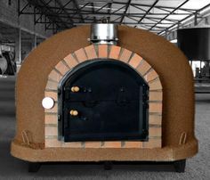 an outdoor brick pizza oven in a warehouse