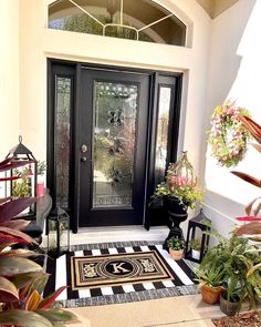 the front door is decorated with potted plants