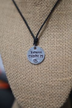 "PRODUCT INFORMATION: - Made on a 1 inch aluminum blank (wearer friendly) - Hangs on a black adjustable cord, about 26 inches at the largest setting - The words \"HYPNOS CABIN 15\" and a swirl are stamped on the pendant - Pendant made to look battered as if it has been in battle. This may include indentations and scuff marks. - These are HANDMADE so they will not be 100% exact copies of what you see in the picture. SHIPPING INFORMATION: - These are not pre-made meaning that I make them as they a Cabin 15 Aesthetic, Hypnos Cabin Aesthetic, Cabin 15 Hypnos Aesthetic, Redo Wardrobe, Hypnos Aesthetic, Percy Jackson Jewelry, Hypnos Cabin, Chb Cabins, Camp Half Blood Cabins