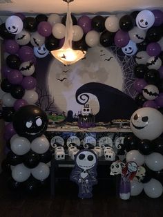 a halloween themed party with balloons and decorations on the wall, including jack skellingy faces