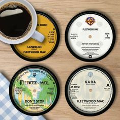 three coasters with different types of records on them and a cup of coffee in the middle