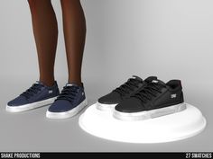 two pairs of shoes are shown on a white surface and one is black, the other is blue