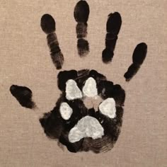 an animal's handprint with white and black paw prints