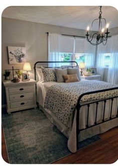 a bed room with a neatly made bed and a chandelier