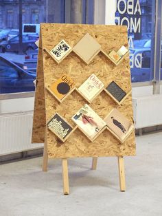 an easel made out of plywood with pictures on it