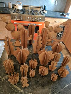 some brown paper decorations are sitting on a table in front of a stove top oven