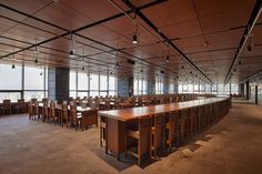 an empty conference room with wooden tables and chairs