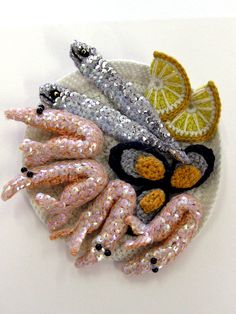 an assortment of sequins and fruit on a plate