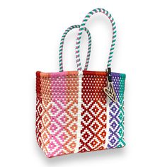 Indulge in luxury with our Vallarta Tote, featuring the timeless Maria Victoria Bag in a captivating handwoven design. Made from repurposed plastic, this versatile bag is perfect for poolside lounging, beach outings, grocery excursions, and everyday tasks. With easy cleaning and fade-resistant colors, you'll never want to leave without it. Measurements: length x depth x height with handle length Extra Large(OT): 17.5x8x18.5 inches with 8 inch handles Large(OR): 15.5x7.5x15 with 8 inch handles Me Maria Victoria, Easy Cleaning, Extra Large, Hand Weaving, Color