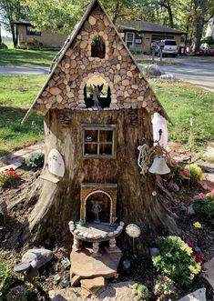 a tree stump with a house made out of logs