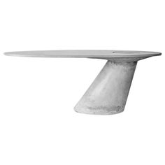 a white table with an oval shaped top on it's pedestal, against a white background