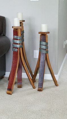 two wooden candlesticks sitting next to each other on top of a carpeted floor