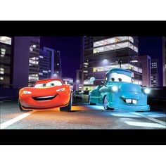 two cars are driving in the city at night