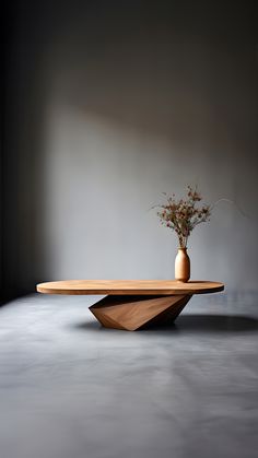 a vase with some flowers in it on top of a wooden table that is shaped like a triangle